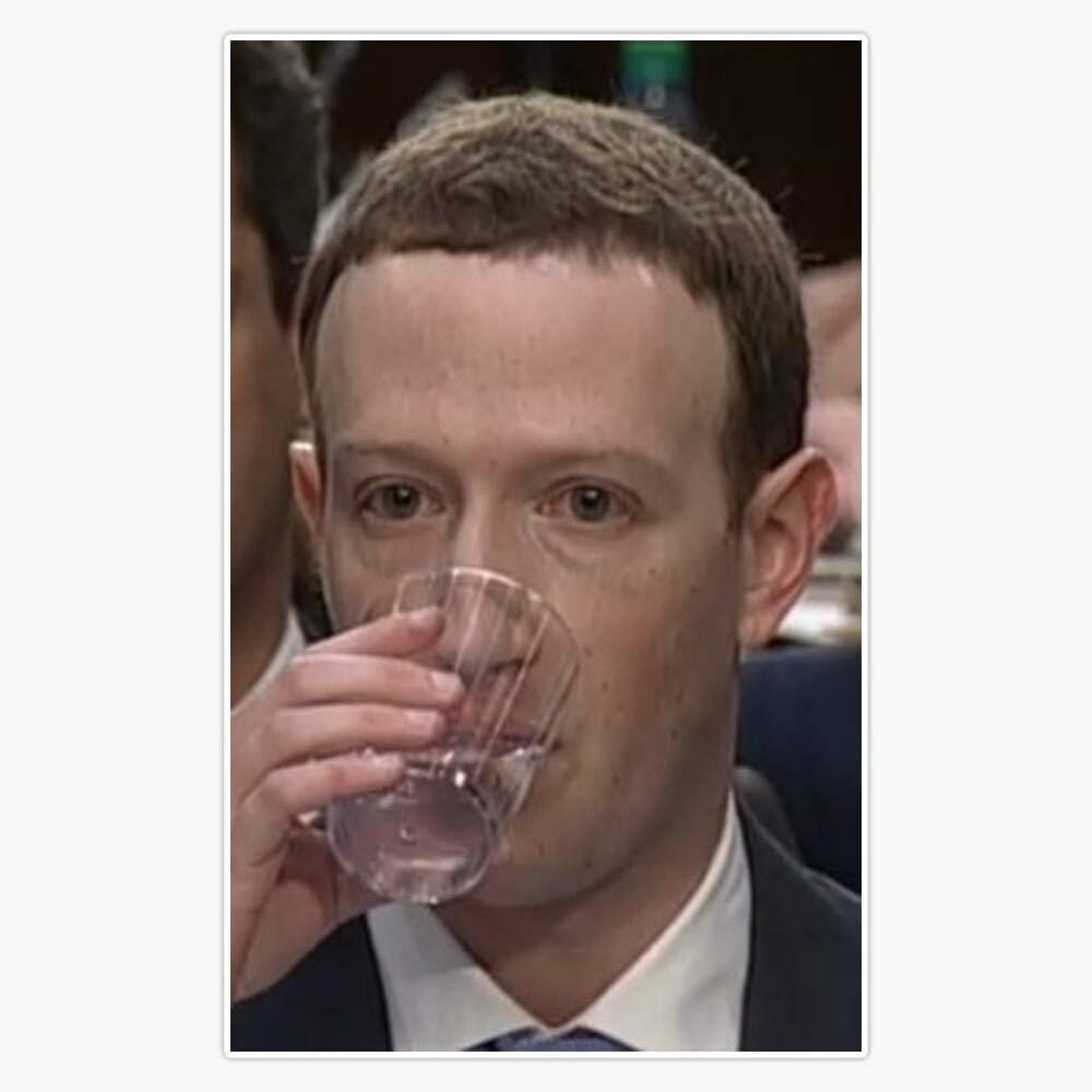 Image shows Mark Zuckerberg taking a sip of water in Congress. He looks slightly nervous.