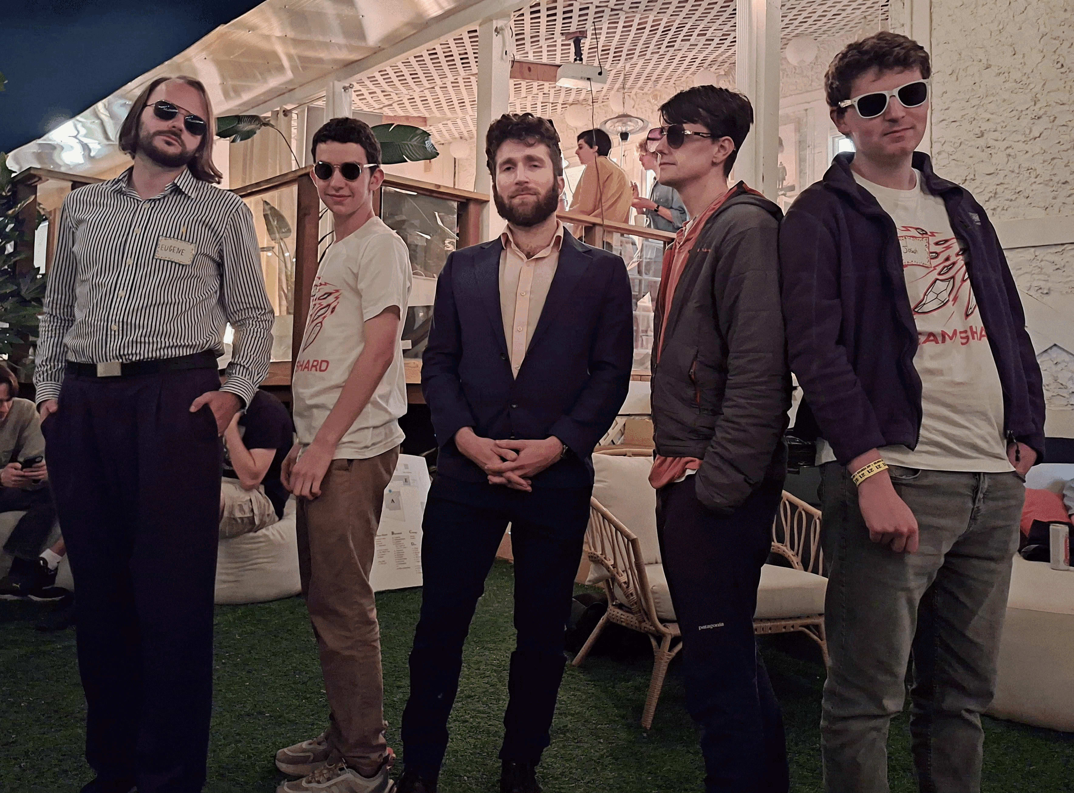 Five men strike a pose at Lighthaven, the community campus. Four of them wear shades while the fifth, Alex, looks at the camera in a blazer.