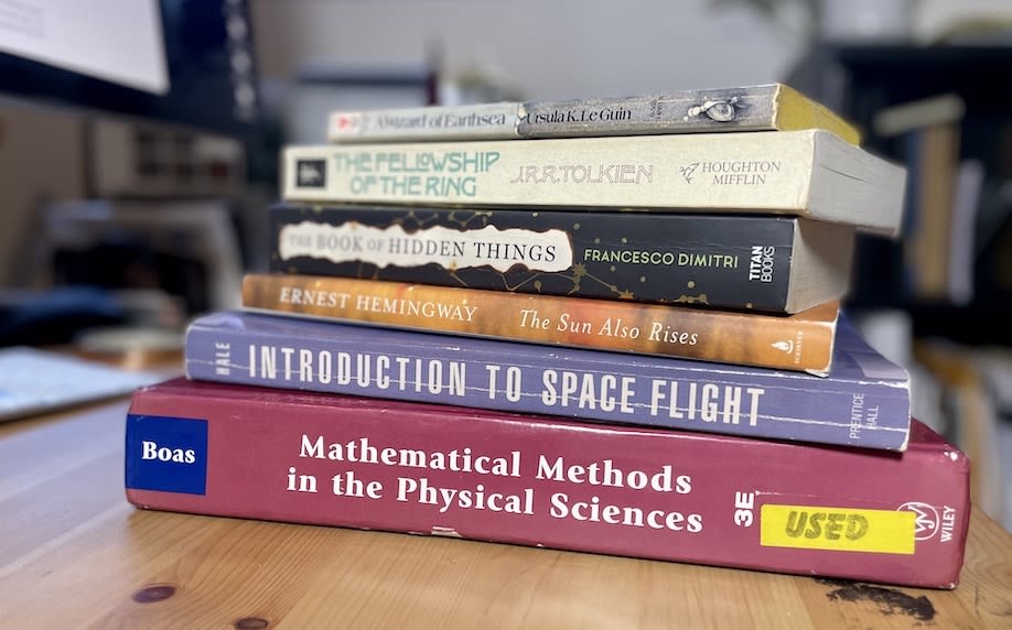 A picture of a set of books on physics together with several good stories and a hint that they are related.