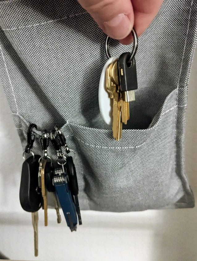 Keys on carabiners lined up next to a smaller key ring