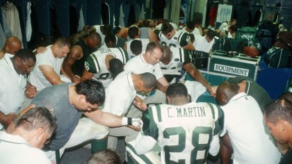 Members of the New York Jets pray following their first game back in action after the attacks, in New England on Sept. 23. (New York Jets)
