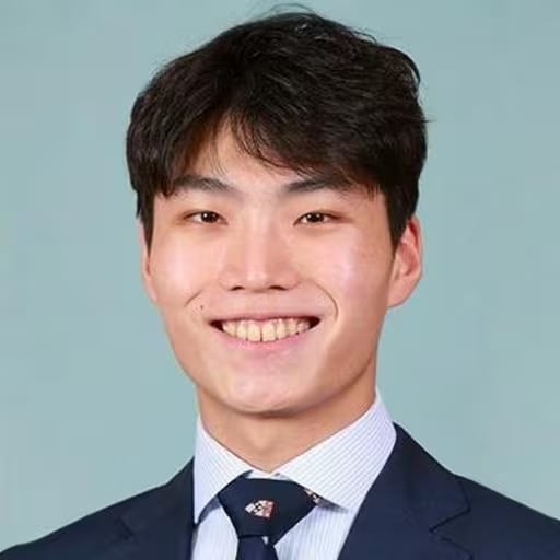 A Korean man flashes a grin.