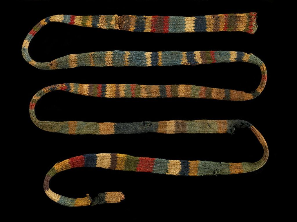 Photo of an old, long, thin knit tube in lots of striped colors.
