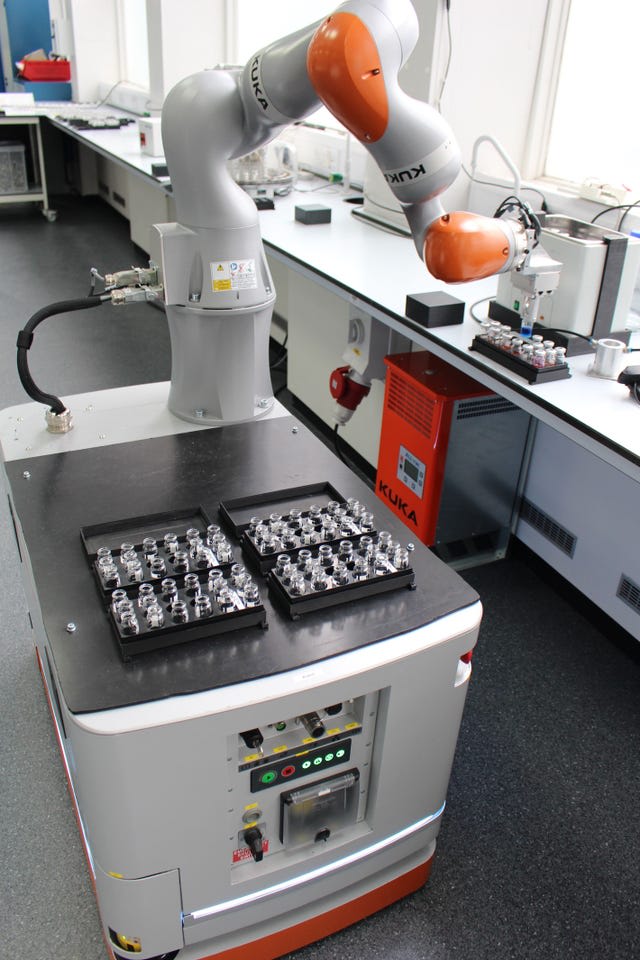 University of Liverpool mobile robotic chemist handling sample vials at a laboratory bench