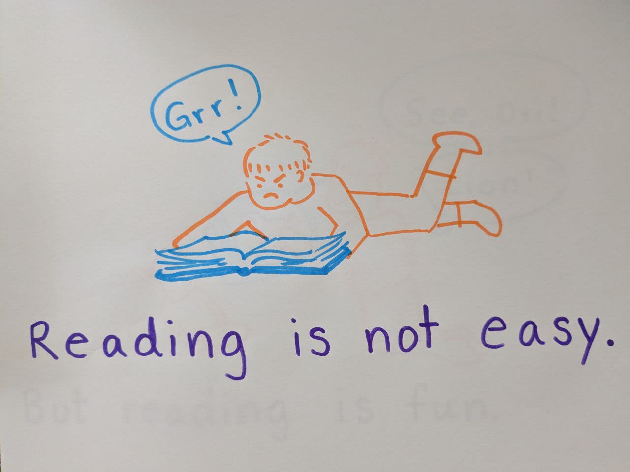 picture of a child holding a book saying "grr!" and the words "Reading is not easy"